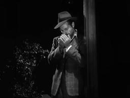Screen capture from Detour (Edgar G. Ulmer, 1945): Al lighting up