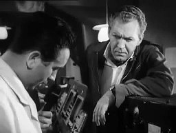 Screen capture from The Trollenberg Terror (The Crawling Eye): Desperate measures: Alan Brooks; Alan listens to the radio operator