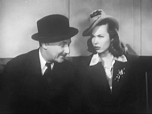 Capture from A Walking Nightmare (The Living Ghost, Lend Me Your Ear): Billie Hilton (Joan Woodbury) and Ed Moline (Paul McVey) in the waiting room of Brother Trayne, The Sympathetic Ear