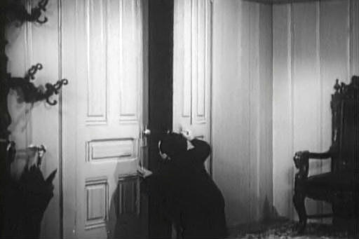 Capture from The Corpse Vanishes: Toby (Angelo Rossitto) Answering the Door