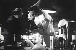 Capture from The Corpse Vanishes: Dr. George Lorenz (Bela Lugosi) and Fagah (Minerva Urecal), Mixing Fluid