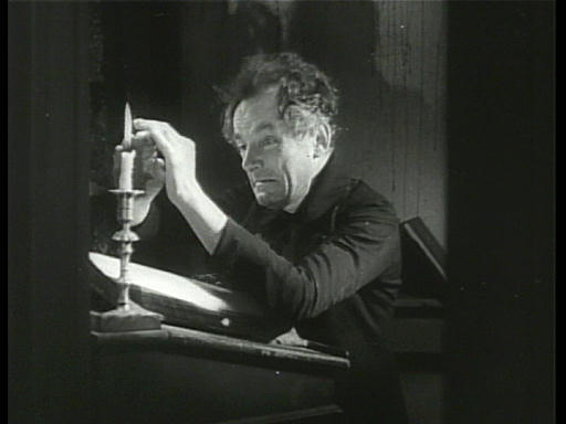 Capture from Scrooge (Henry Edwards, 1935), Bob Cratchit (Donald Calthrop), Trying to warm himself at the candle